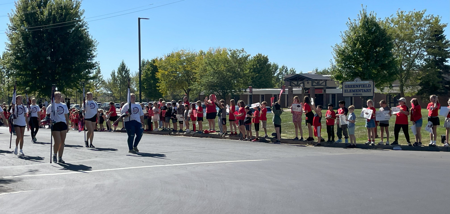 Marching band performing for elementary.