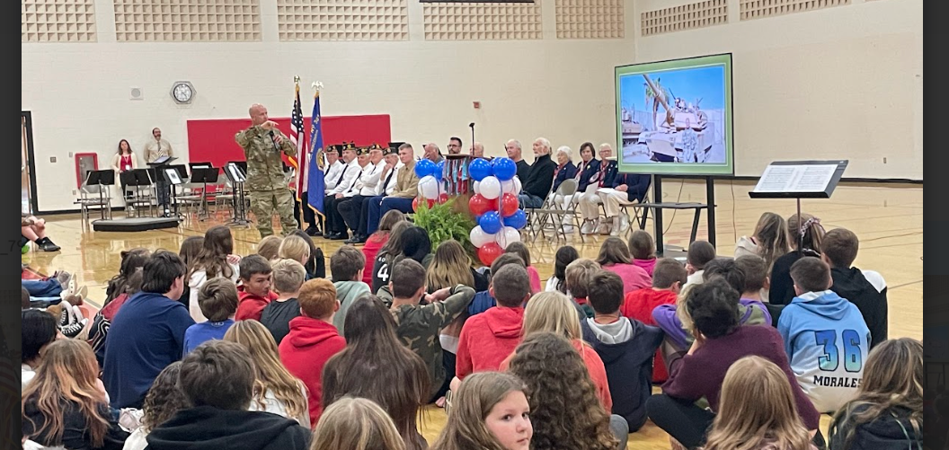 Veteran addressing a crowd of students.