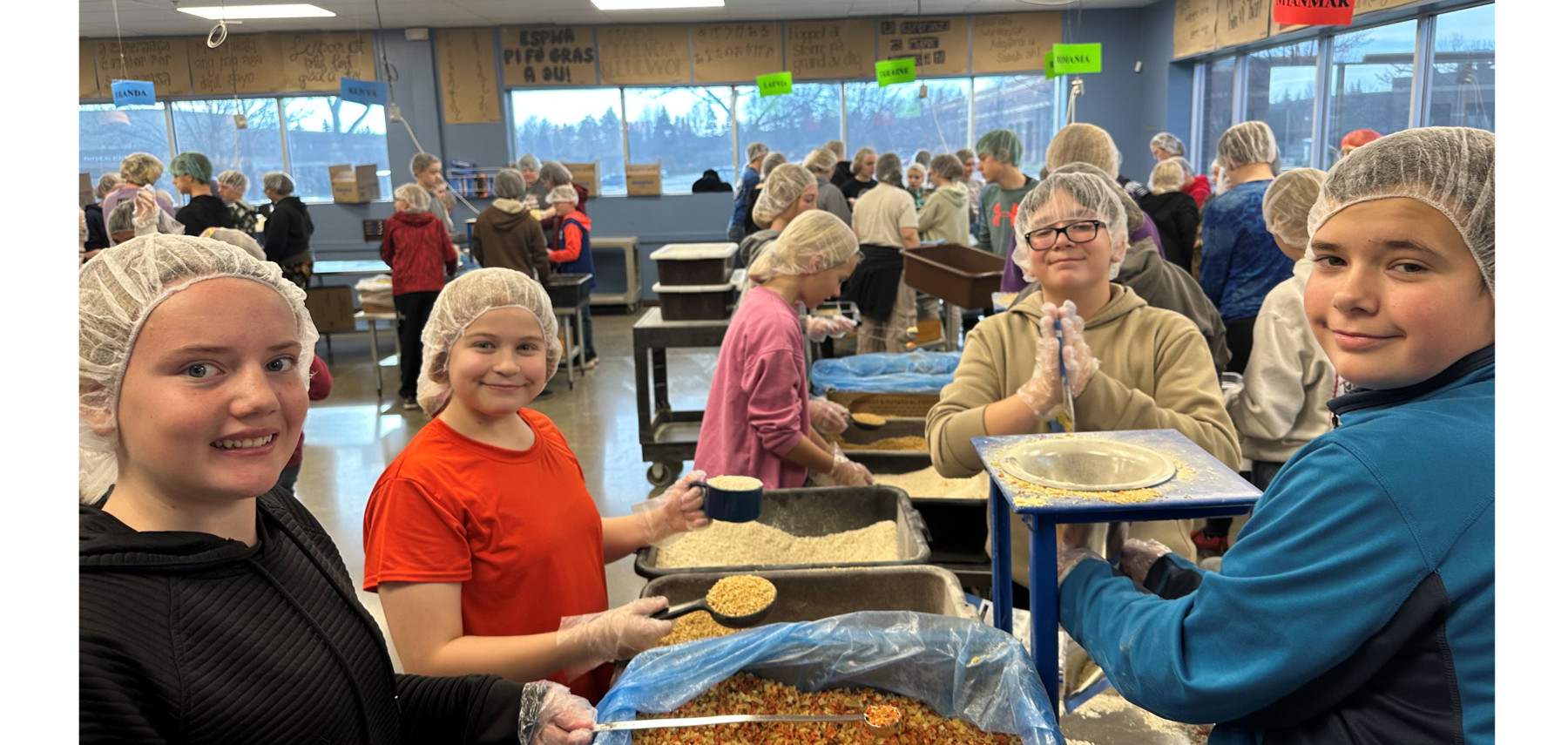 Students packing meals with Feed My Starving Children organization.